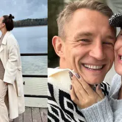 Jakub Rutnicki i jego żona, uśmiechnięci i zakochani, dzielą się czułym pocałunkiem nad jeziorem.