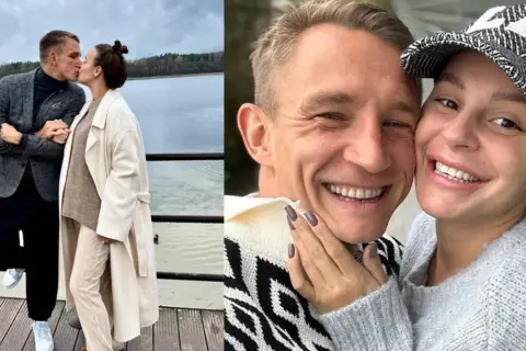 Jakub Rutnicki i jego żona, uśmiechnięci i zakochani, dzielą się czułym pocałunkiem nad jeziorem.