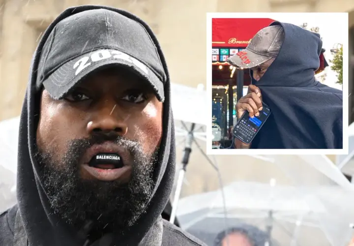 Kanye West zaginal, ukryty pod czarnym kapturem i czapką, z napisem Balenciaga na ustach.