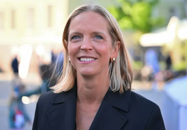 Uśmiechnięta Małgorzata Trzaskowska, której wykształcenie jest szeroko komentowane, w czarnym żakiecie.