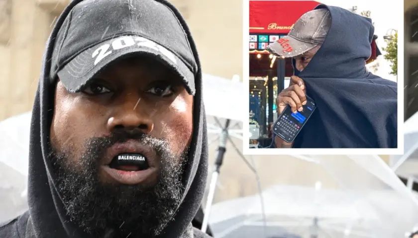 Kanye West zaginal, ukryty pod czarnym kapturem i czapką, z napisem Balenciaga na ustach.