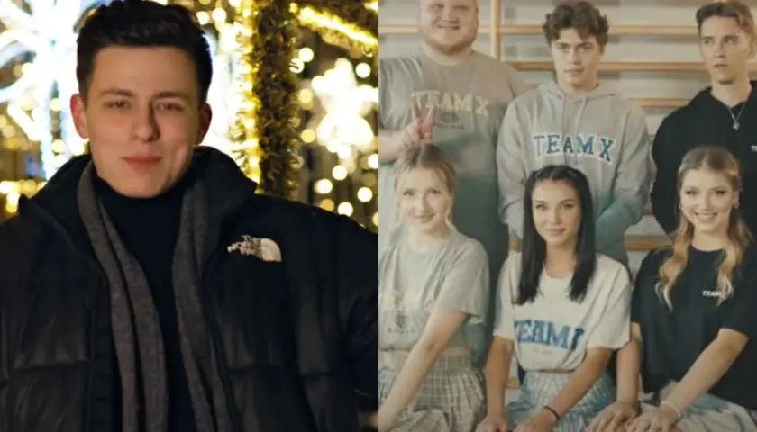 Młody mężczyzna przed świątecznymi iluminacjami i grupa osób w strojach z napisem TEAM X, jakby po obozie.