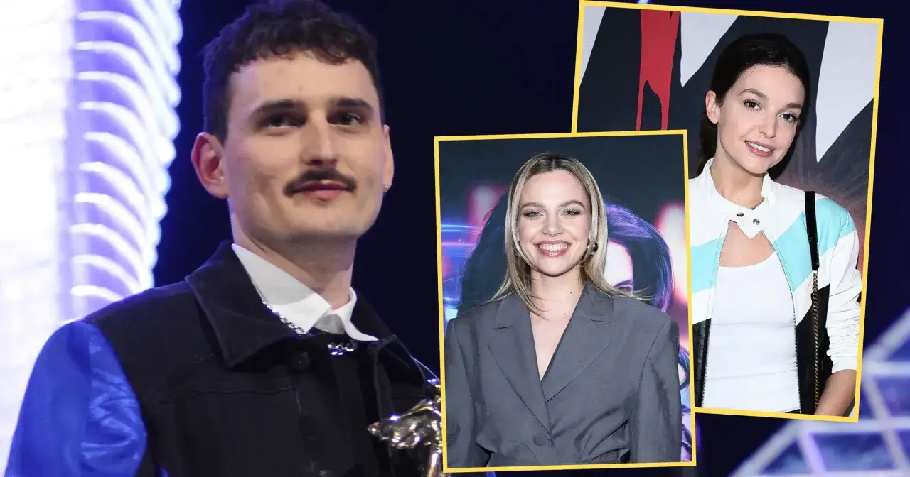 Dawid Podsiadło z dziewczyną na zdjęciu. Wesoła blondynka w szarym garniturze i brunetka w kurtce z kolorowymi pasami.